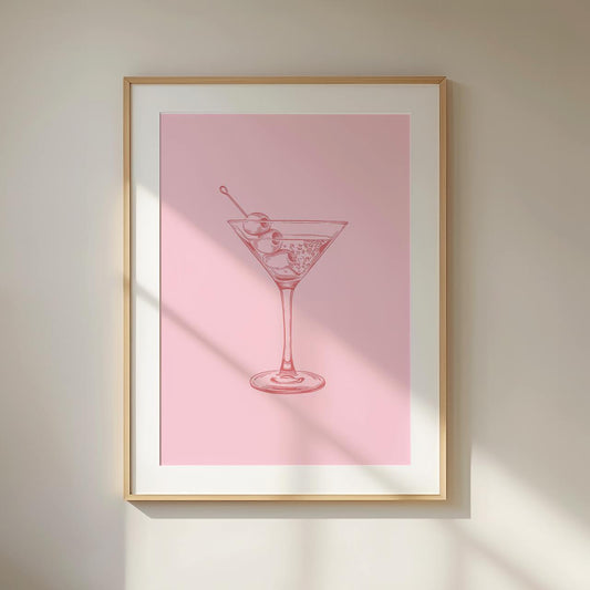 Framed artwork of a martini glass on a pink background