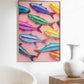 Framed artwork of colorful fish on a pink background in a living room setting.