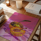Colorful disco ball pumpkin on a pink background on a wooden table with books and a lamp.