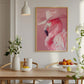 Dining room with a pink flamingo poster on the wall, wooden table, and decorative items.