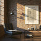Modern living room with brick wall, sofa, coffee table, and framed poster.