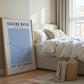 Framed poster with motivational quote in a bedroom setting