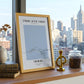 Framed artwork on a windowsill with cityscape view