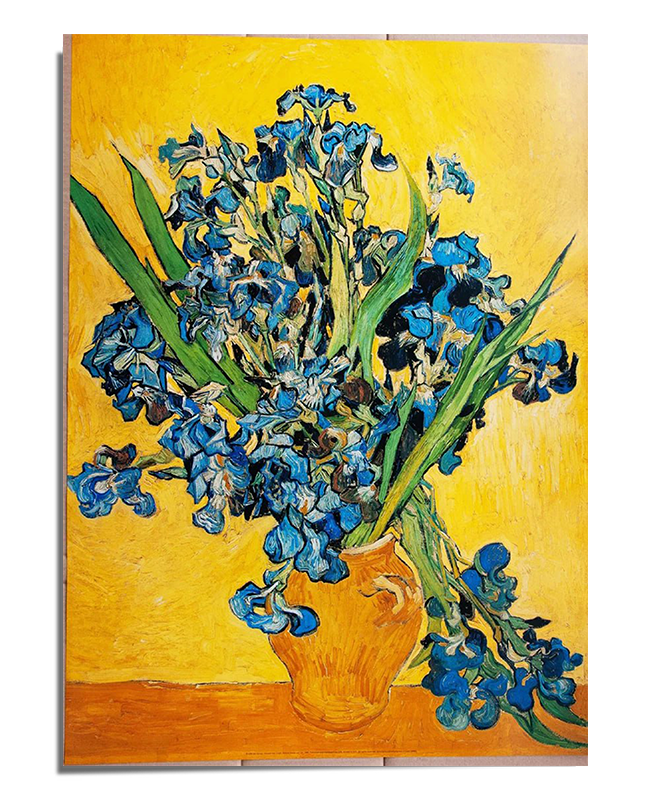 A bouquet of irises in shades of deep blue and violet with long green stems and leaves, arranged in a textured, golden-brown ceramic vase. The flowers appear lively, with swirling brushstrokes adding movement. The background is a rich golden yellow, contrasting with the cool tones of the irises. The artwork is framed with a white border, featuring the text "Vincent van Gogh – Irises 1890" at the bottom