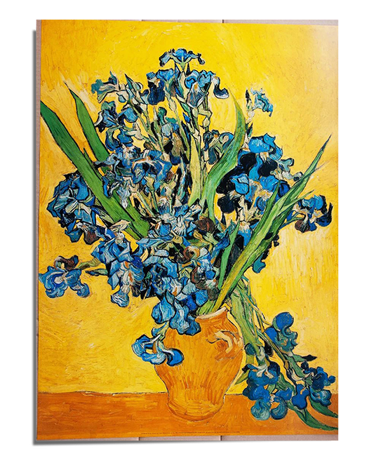 A bouquet of irises in shades of deep blue and violet with long green stems and leaves, arranged in a textured, golden-brown ceramic vase. The flowers appear lively, with swirling brushstrokes adding movement. The background is a rich golden yellow, contrasting with the cool tones of the irises. The artwork is framed with a white border, featuring the text "Vincent van Gogh – Irises 1890" at the bottom